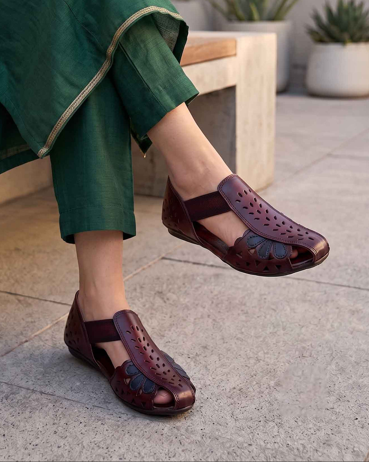 Women's maroon leather closed-toe mules with cut-out pattern and elastic back strap, on-foot view