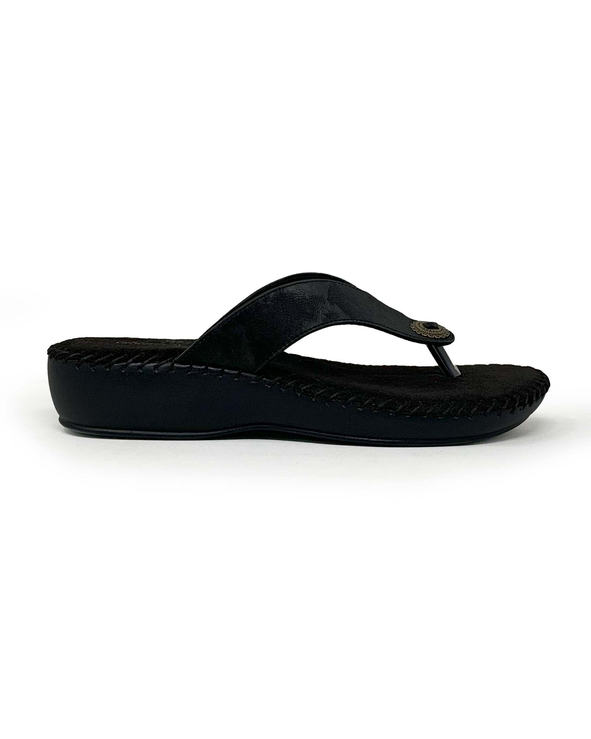 Women's black suede thong comfort flat with metal disc accent and low cushioned sole, side view
