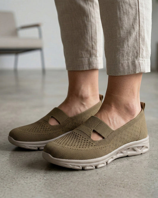 Women's beige knit slip-on walking shoes with cut-out strap and cushioned white sole, on-foot view